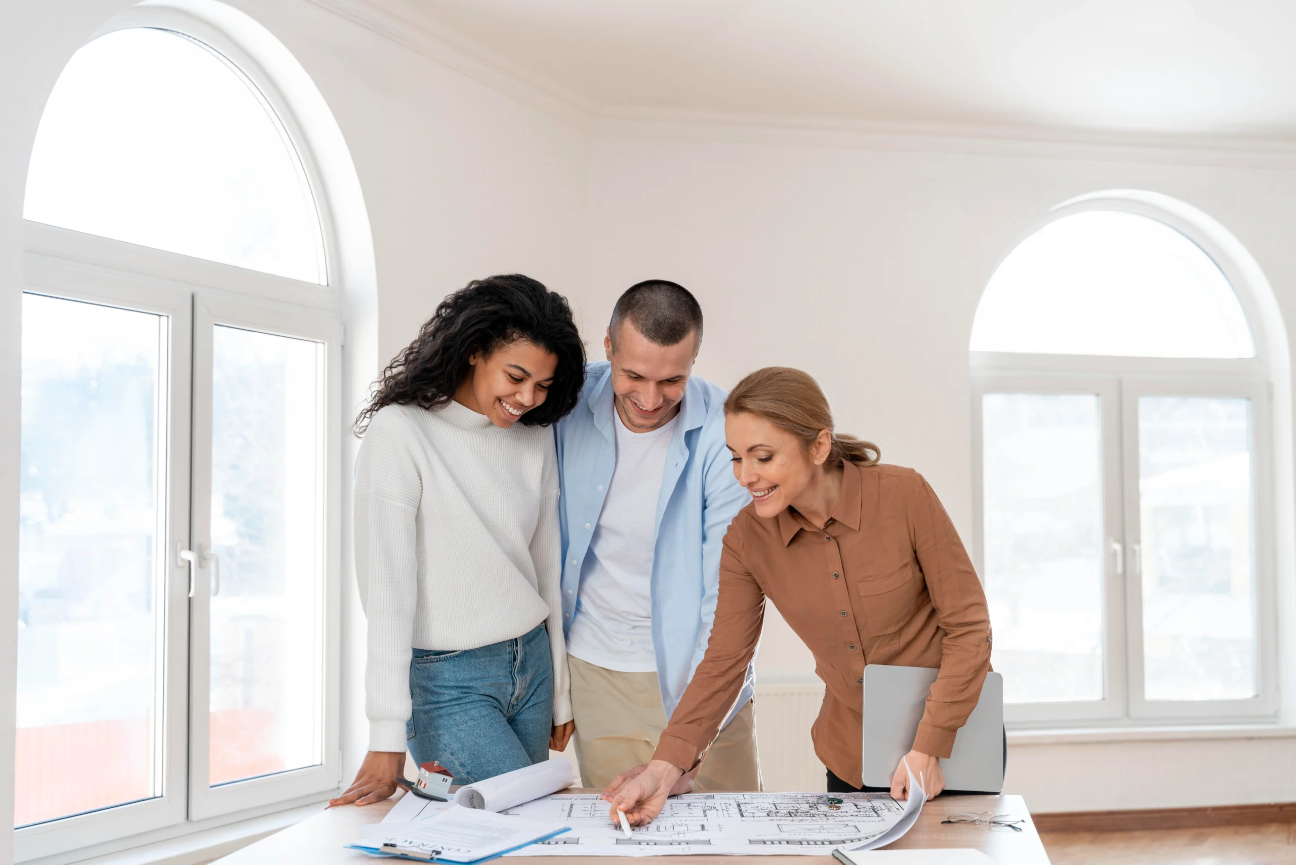 front-view-female-realtor-showing-new-house-plan-couple-scaled